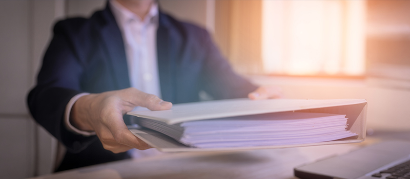 Businessman handing over documents