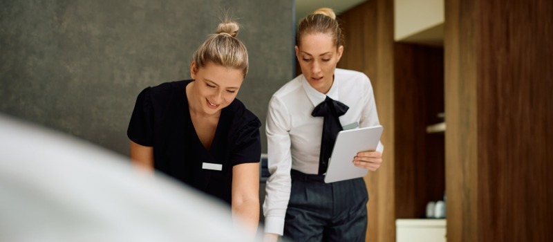 Hotel staff member receiving training in a suite