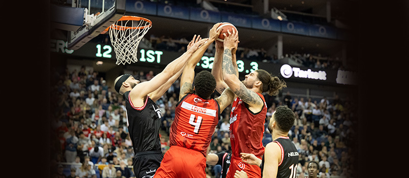 Basketball players jumping for rebound