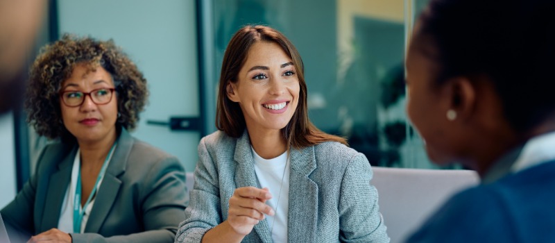 Inside the women-first network rethinking digital employee experience Professional women in an office setting