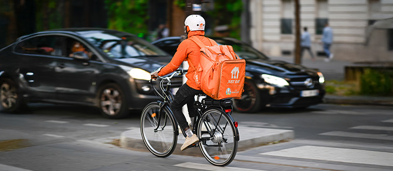 Food delivery cyclist in city