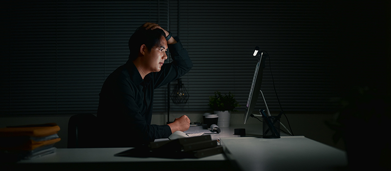 Stressed man working late night