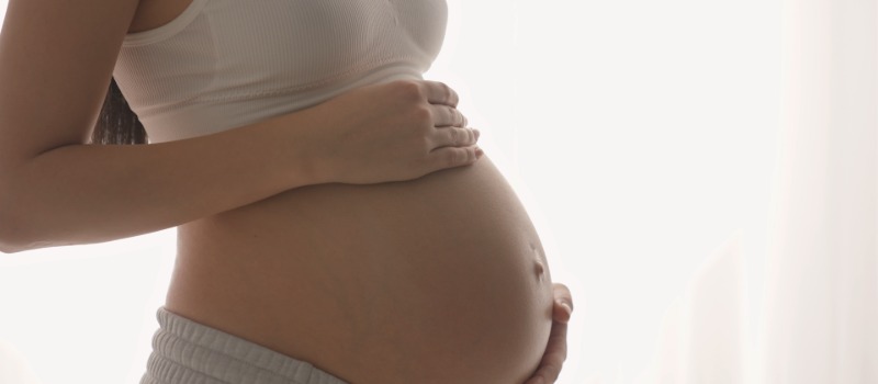 Pregnant woman holding belly