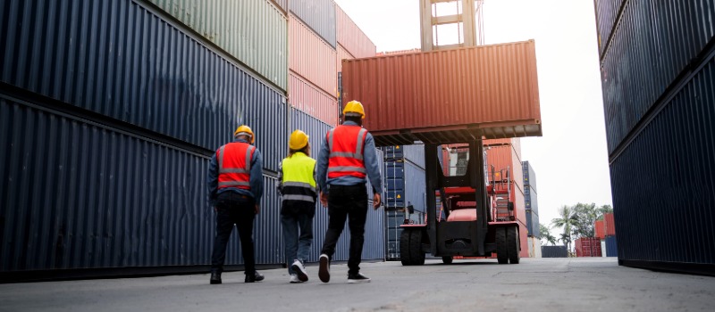 Workers at shipping container yard