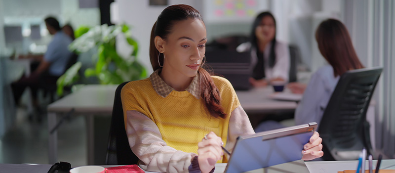 Woman working on digital tablet
