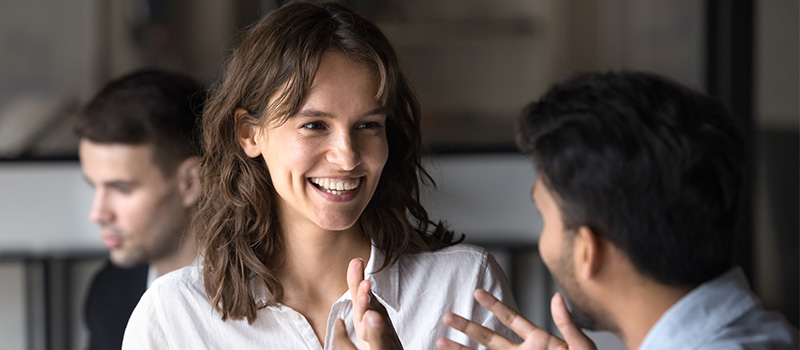 Smiling colleagues having friendly conversation