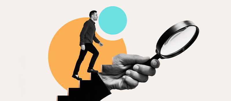 Man climbing stairs with magnifying glass