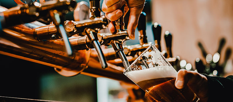 Pouring draft beer at bar