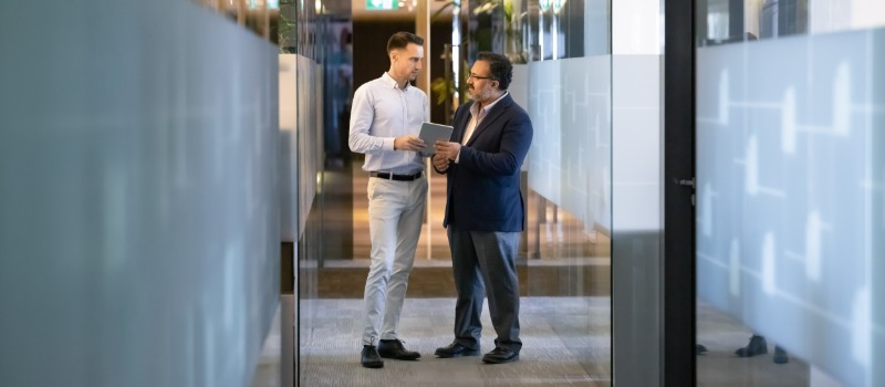 Business professionals discussing in hallway
