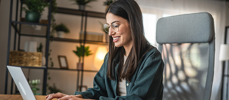 Woman working on laptop home