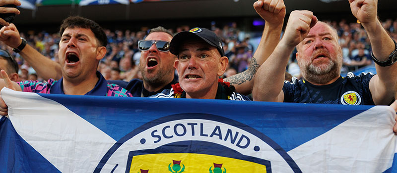 Scotland football fans cheering flag