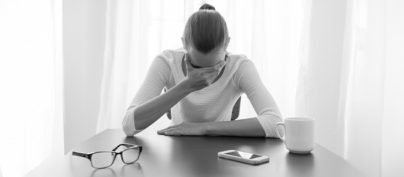 Heartbroken woman at work desk