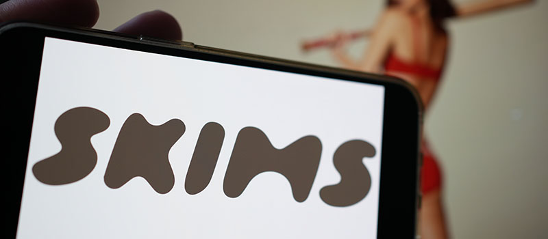 SKIMS logo on smartphone display