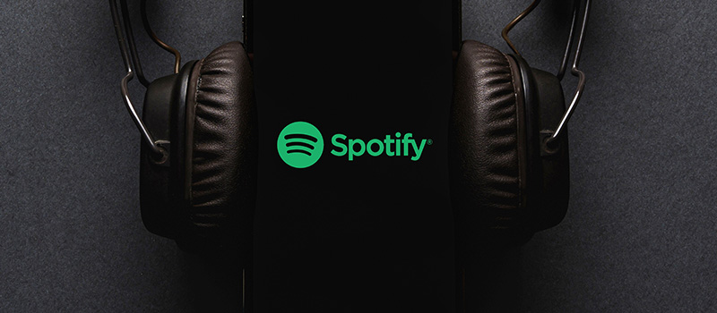 Spotify logo with headphones dark background