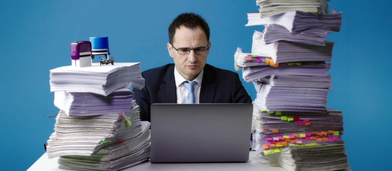 Stressed office worker with paperwork