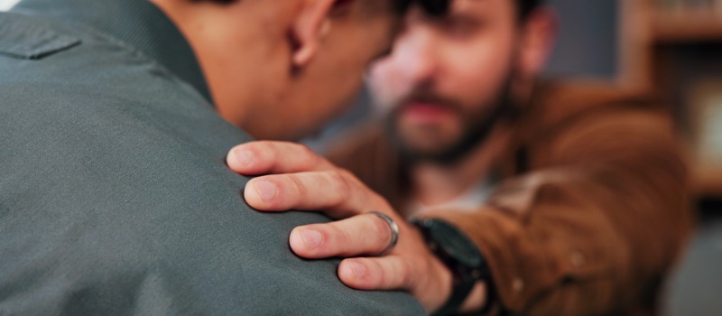 Man comforting friend with empathy