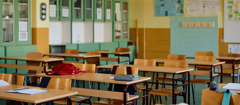 Empty classroom with wooden desks
