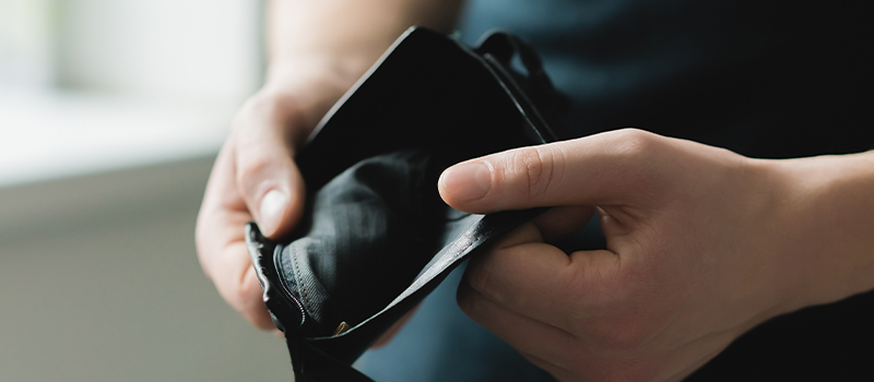 Empty wallet in person's hands
