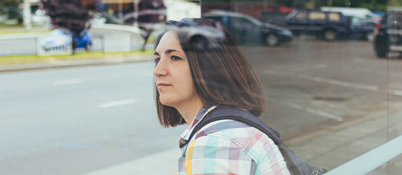 Woman waiting at bus stop