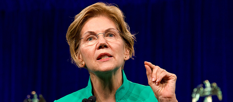 Sen. Elizabeth Warren speaking at podium passionately