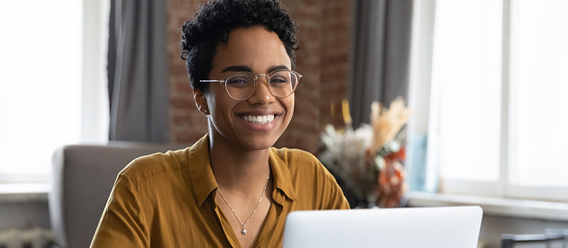 Smiling woman working on laptop