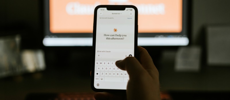 Person using Claude AI on smartphone