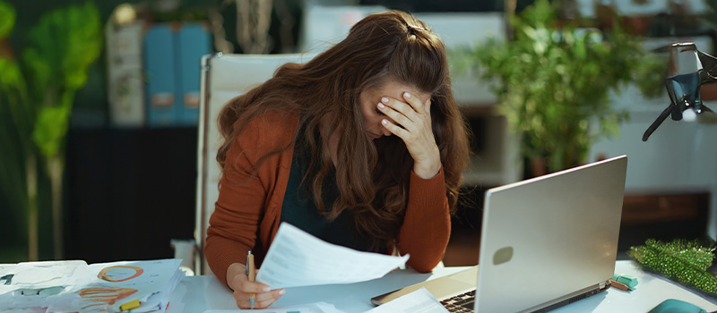 Stressed woman working at desk