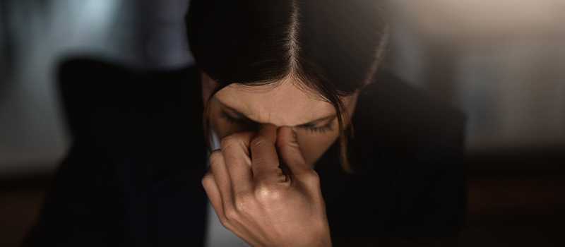 Stressed woman holding her face