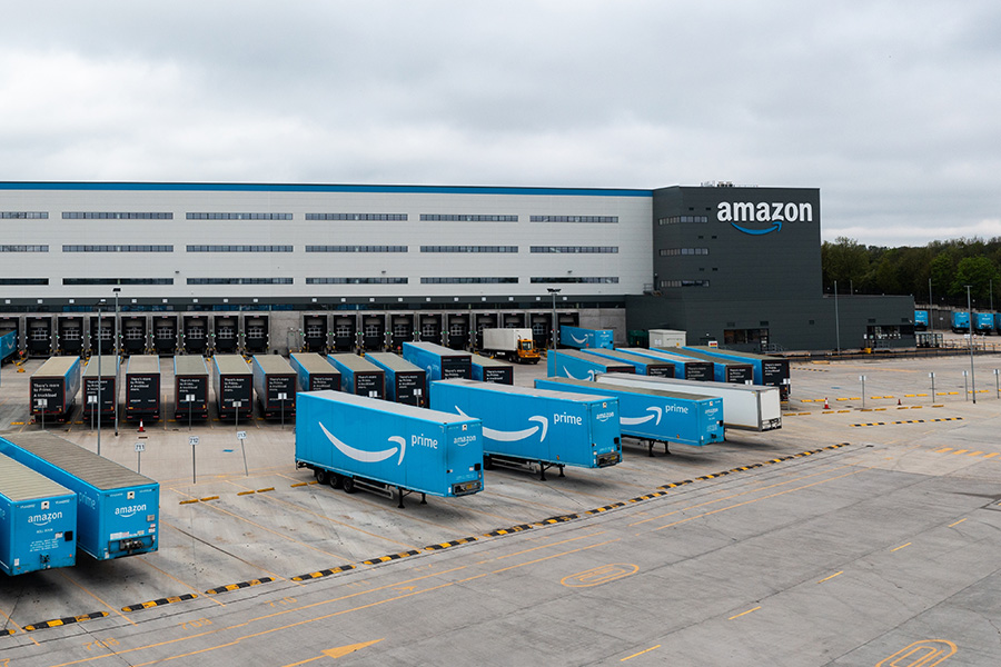 Amazon set to cut thousands more jobs, including HR roles amid strategic reset Amazon warehouse with Prime trucks