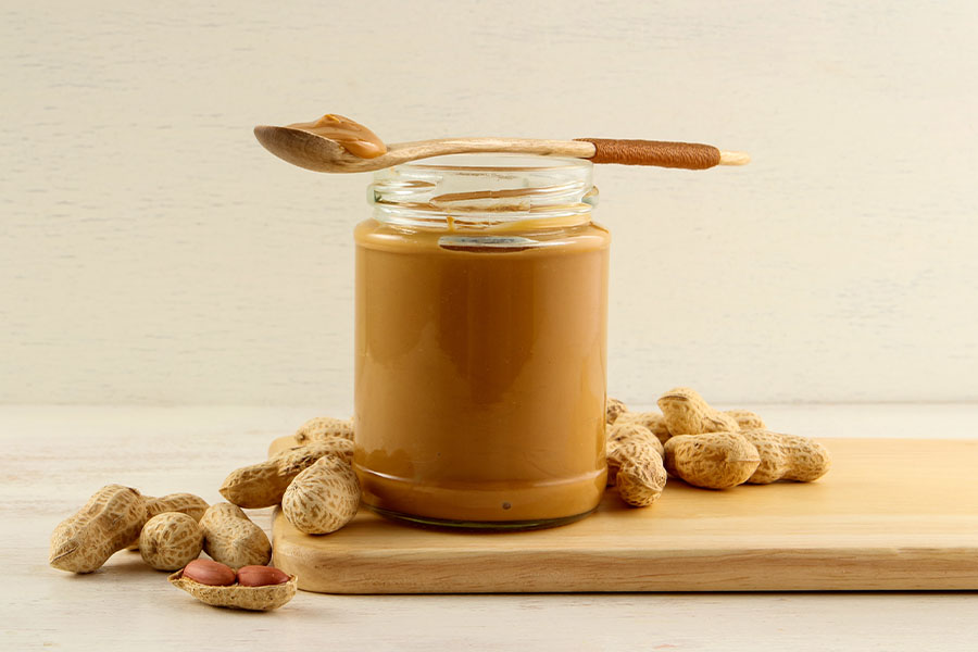 Peanut butter jar with peanuts