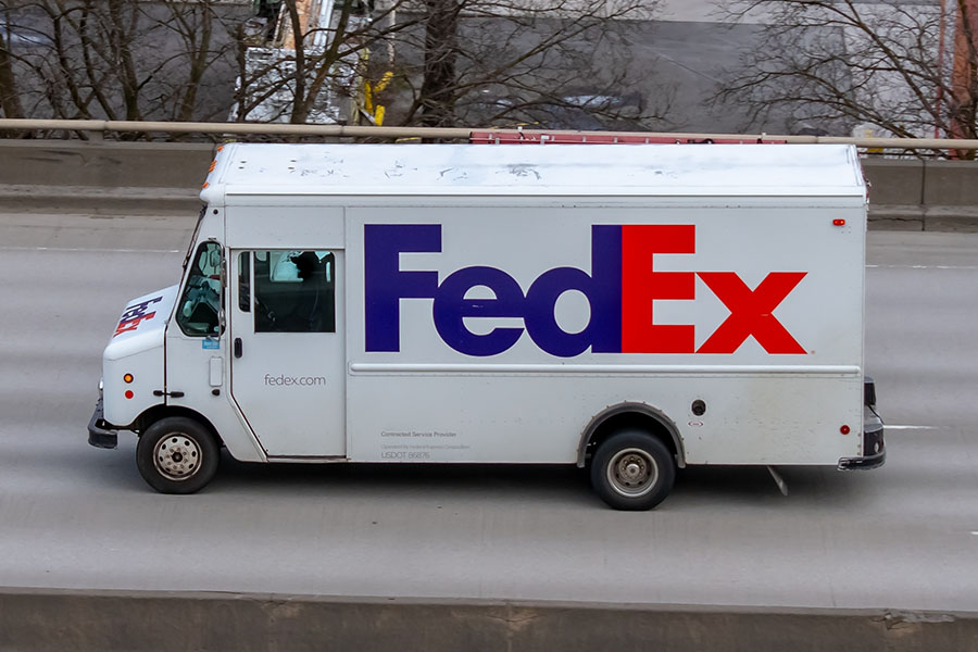 Why FedEx is launching a global AI education program for employees FedEx delivery truck on road