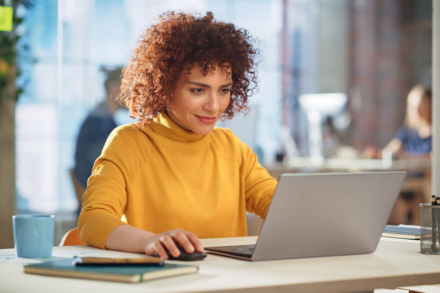 Woman working on laptop smiling