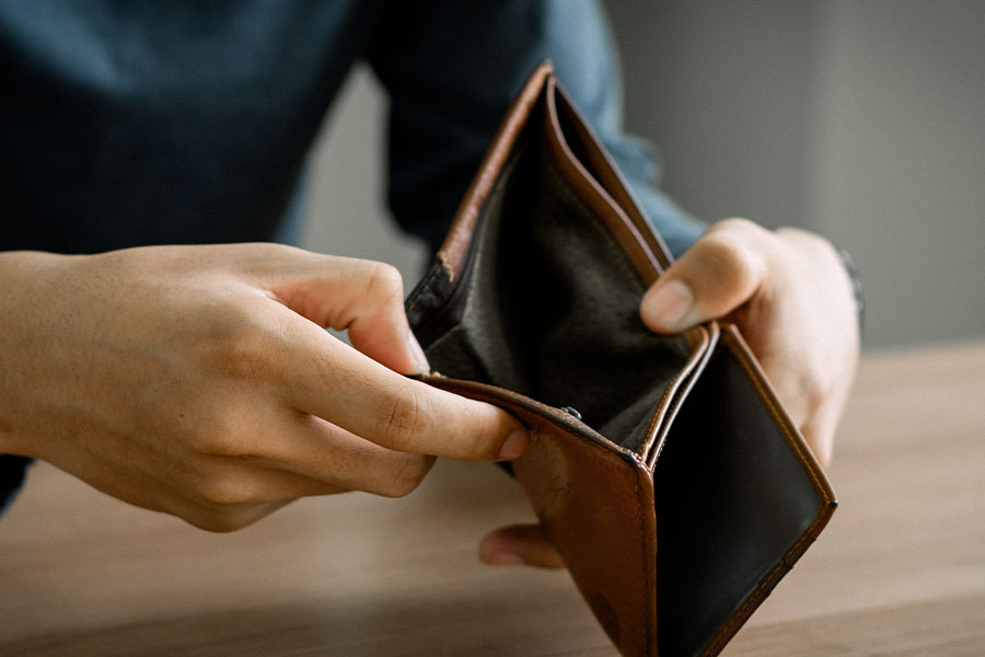 Empty wallet in person's hands