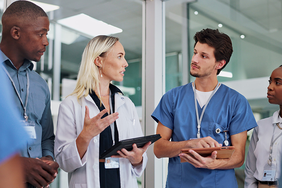Major exodus of US healthcare workers looms, experts call for more 'career advancement' Diverse medical team discussing patient