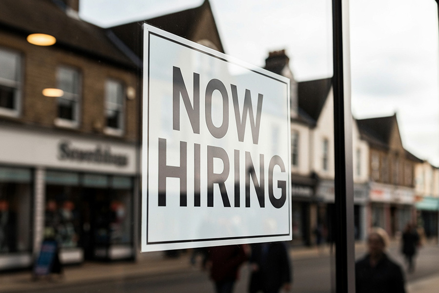 Now hiring sign on window
