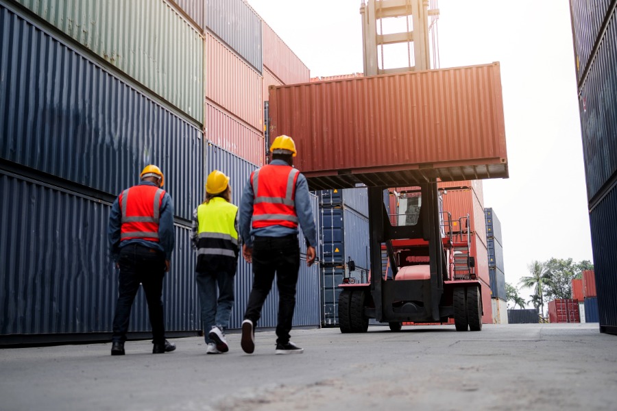 Workers at shipping container yard