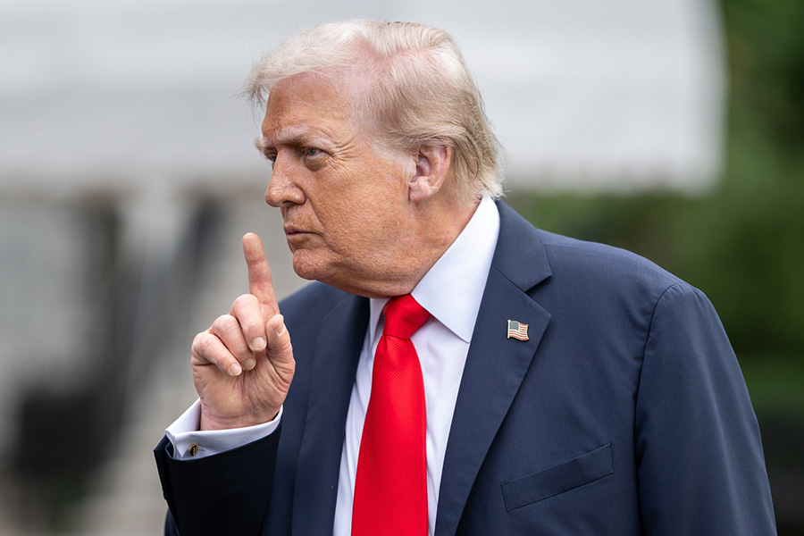 Donald Trump in suit raising finger