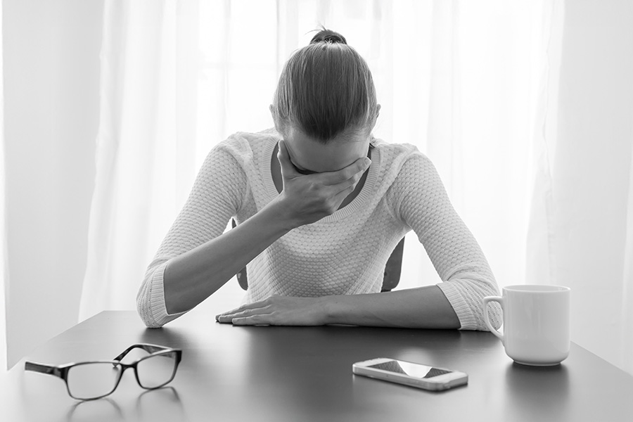 Heartbroken woman at work desk