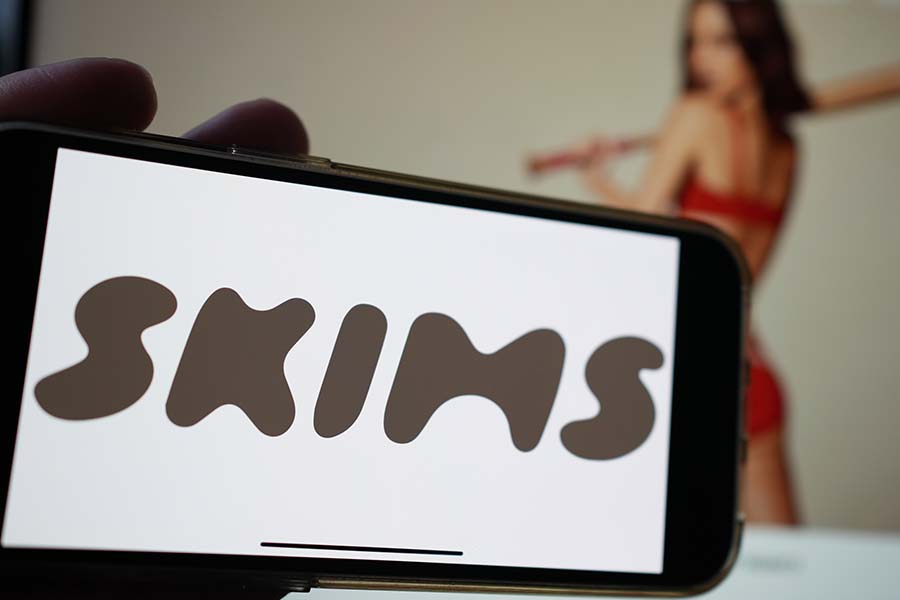 SKIMS logo on smartphone display