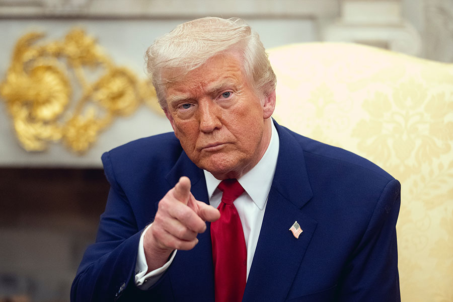 Donald Trump in suit pointing forward