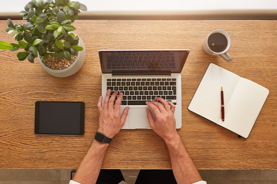 Person working on laptop desk